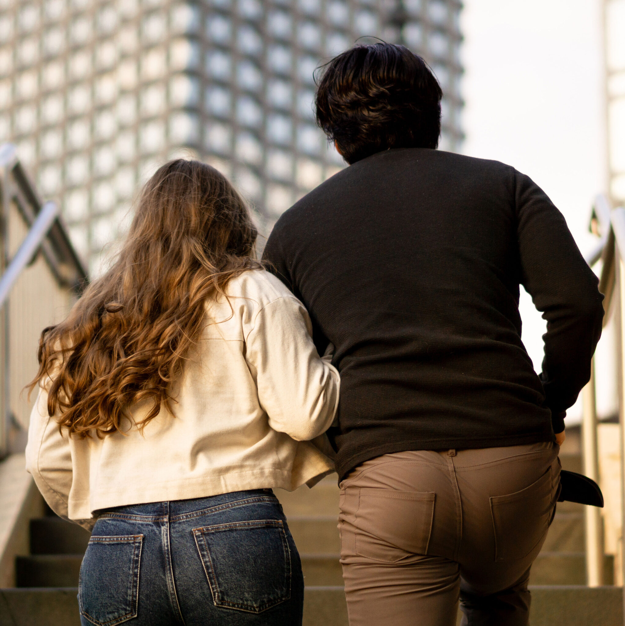 Female and male walking up stairs in downtown Chicago
