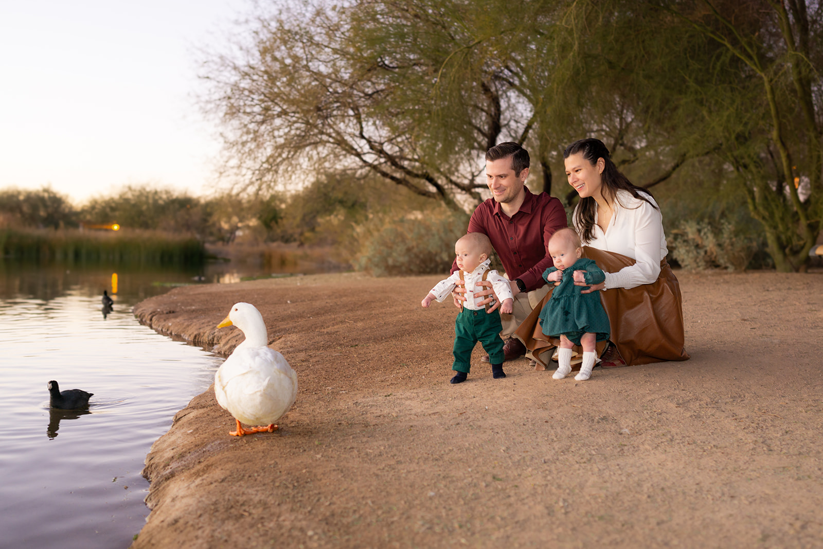 Family of four with ducks at veteran oasis park