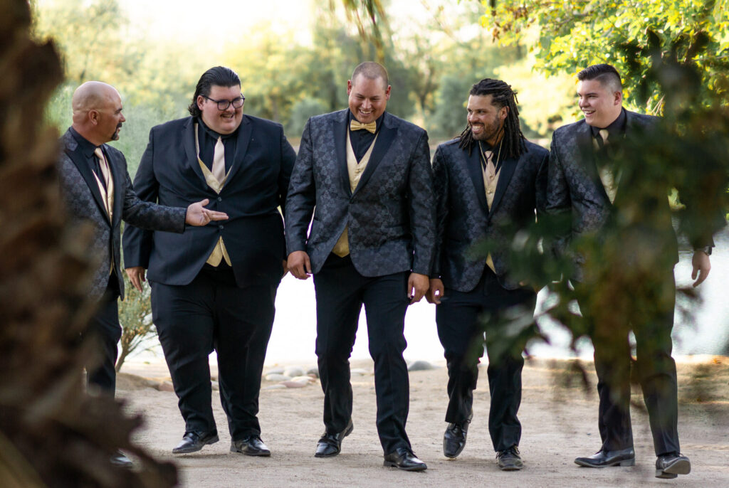 Four groomsmen walking with groom in a row