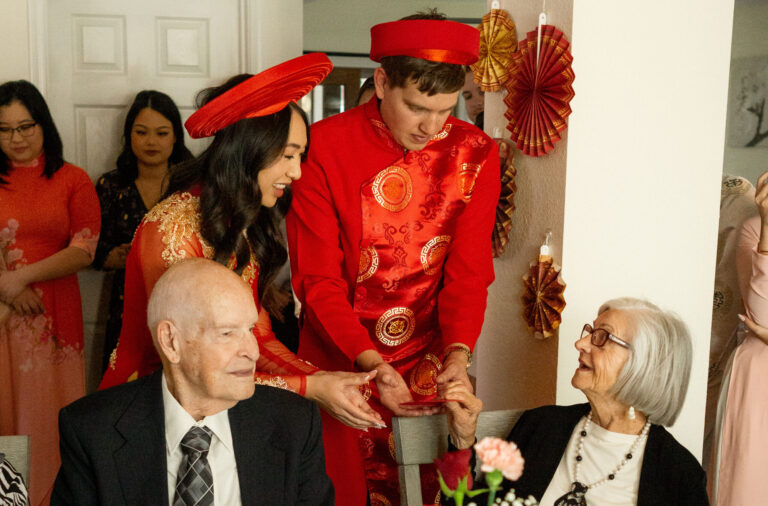 couple serving tea to grandparents during Vietnamese tea ceremony