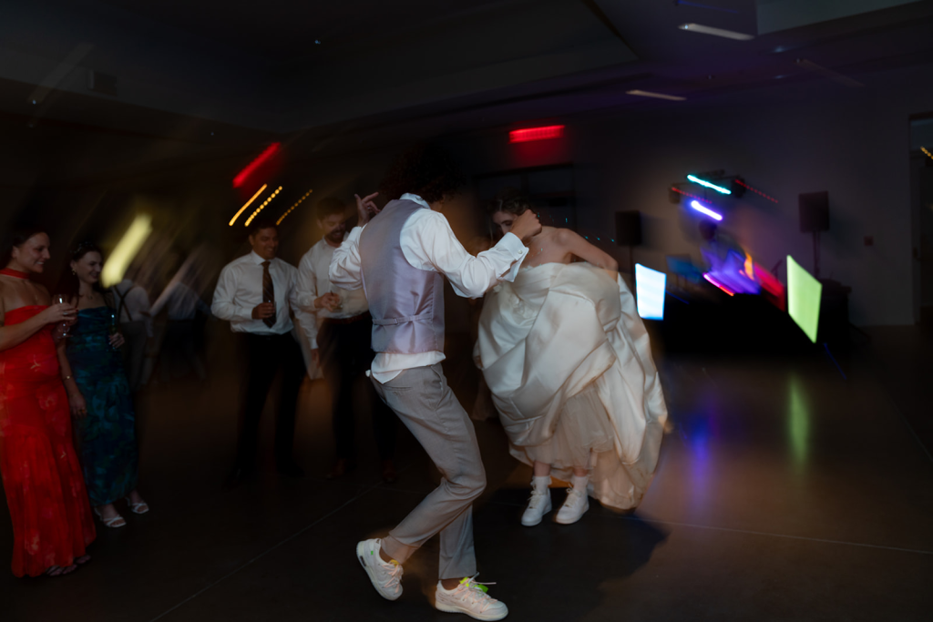 candid photo using direct flash on bride and groom dancing on dance floor at their wedding