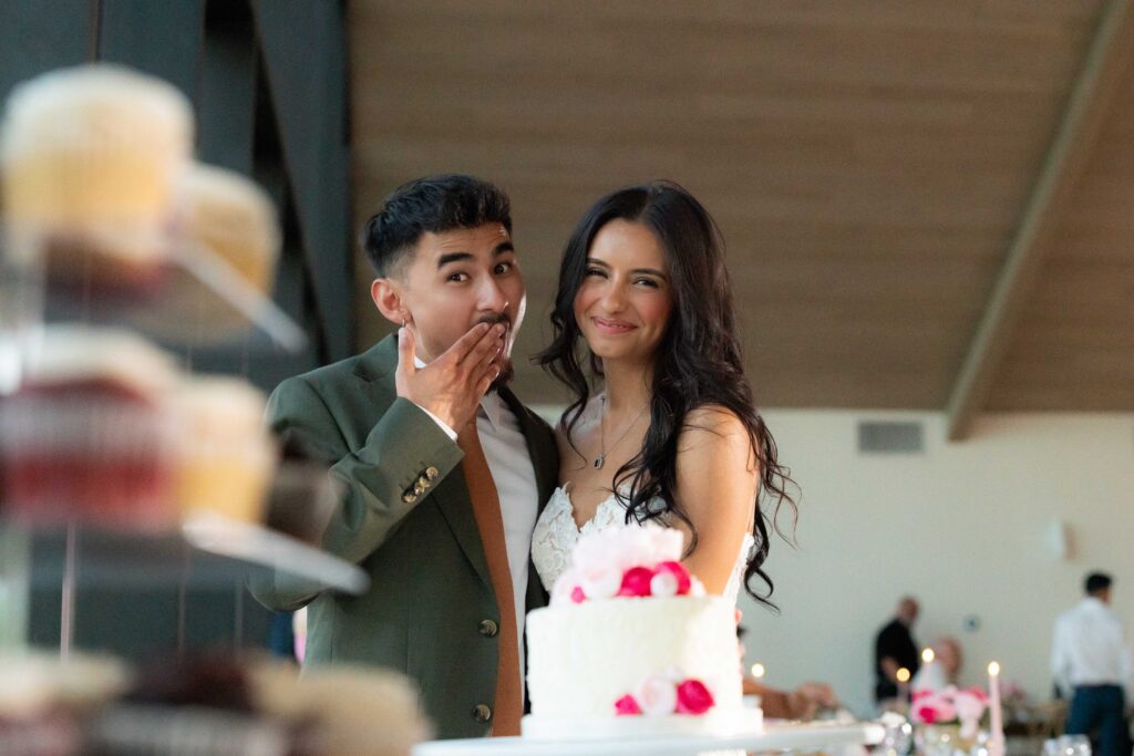 bride and groom smiling after cake cutting