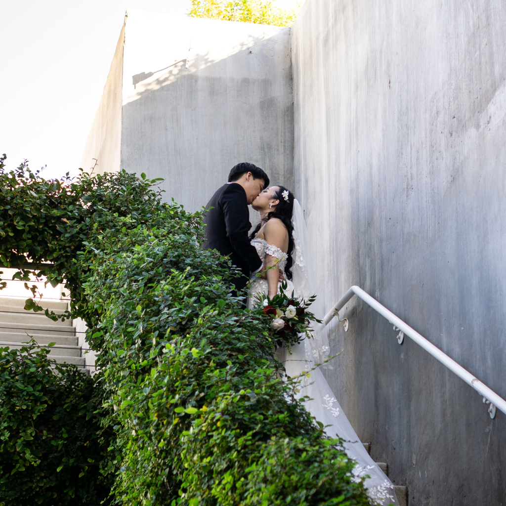 bride and groom kissing on stairs at mountain shadows resort