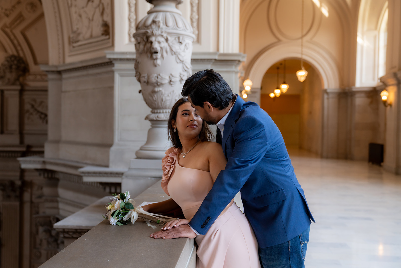 couple staring at each other lovingly in san francisco city hall after eloping