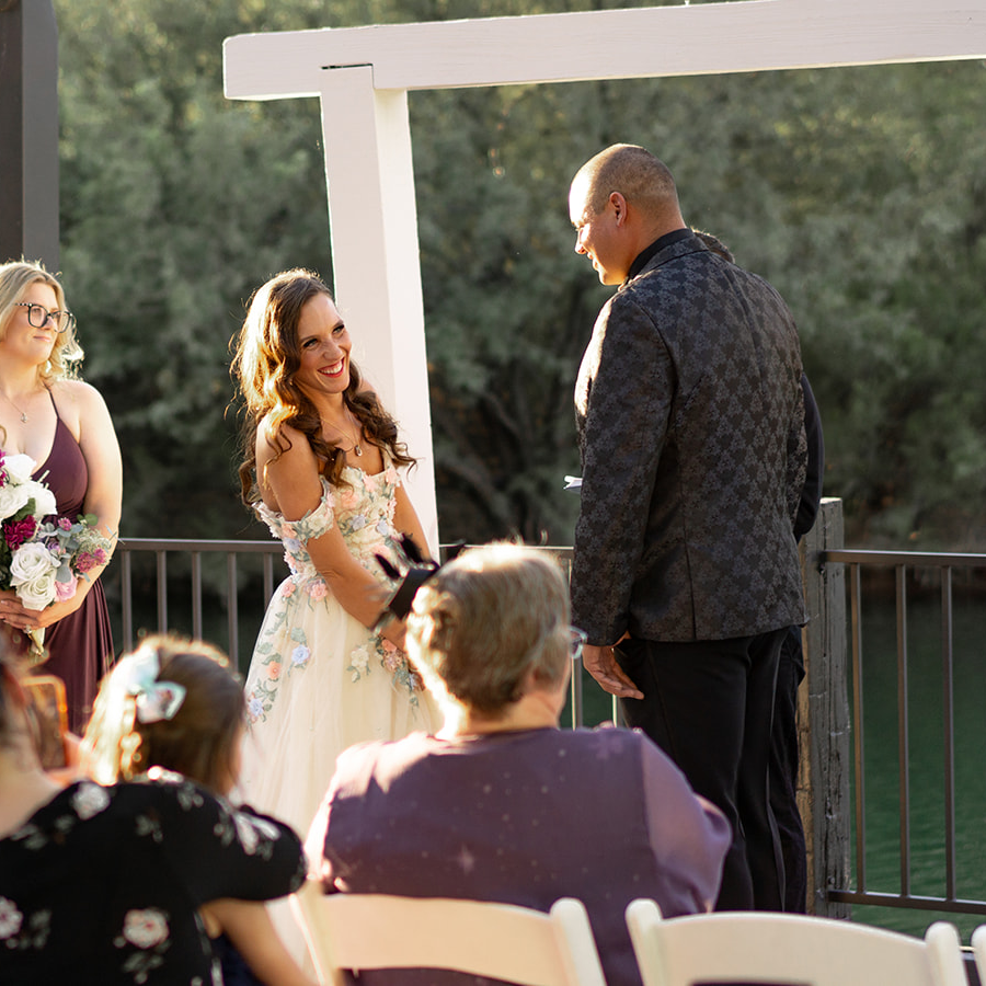 candid photo of bride smiling during wedding ceremony at windmill winery in arizona