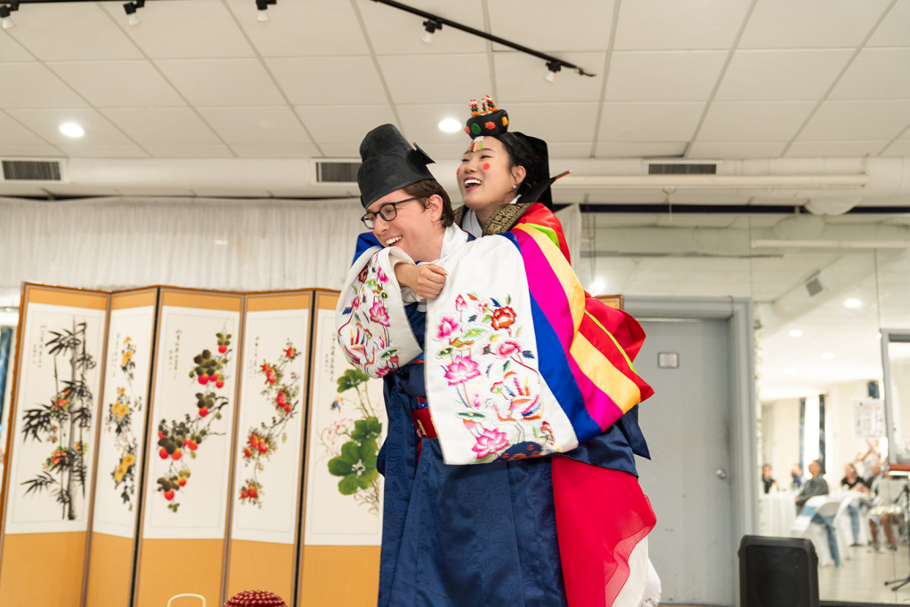 groom giving bride piggyback ride during paebaek