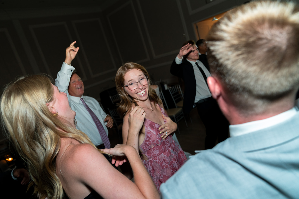 candid photo of woman wearing glasses and dancing at a wedding reception in Aristide venue in Colleyville, texas
