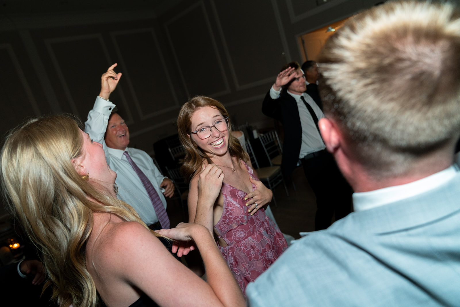 candid photo of woman wearing glasses and dancing at a wedding reception in Aristide venue in Colleyville, texas