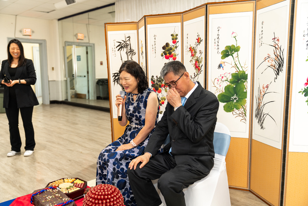 parents giving advice during korean paebaek tea ceremony. dad is emotional and wiping a tear