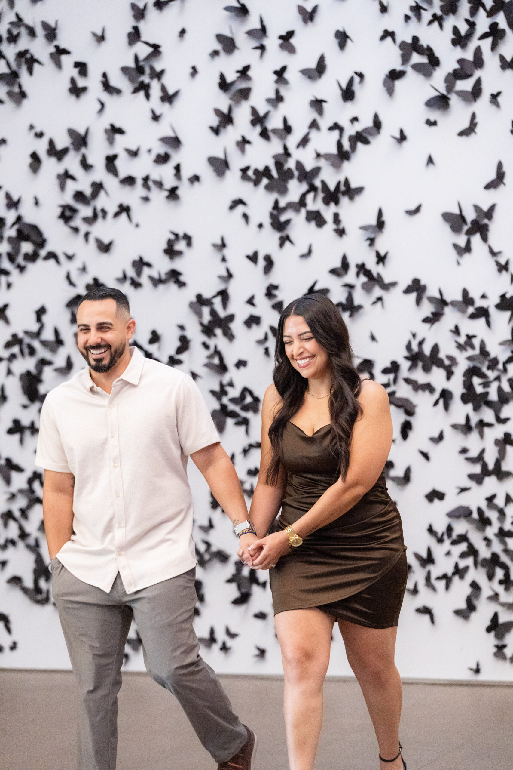 couple walking during engagement shoot at phoenix art museum