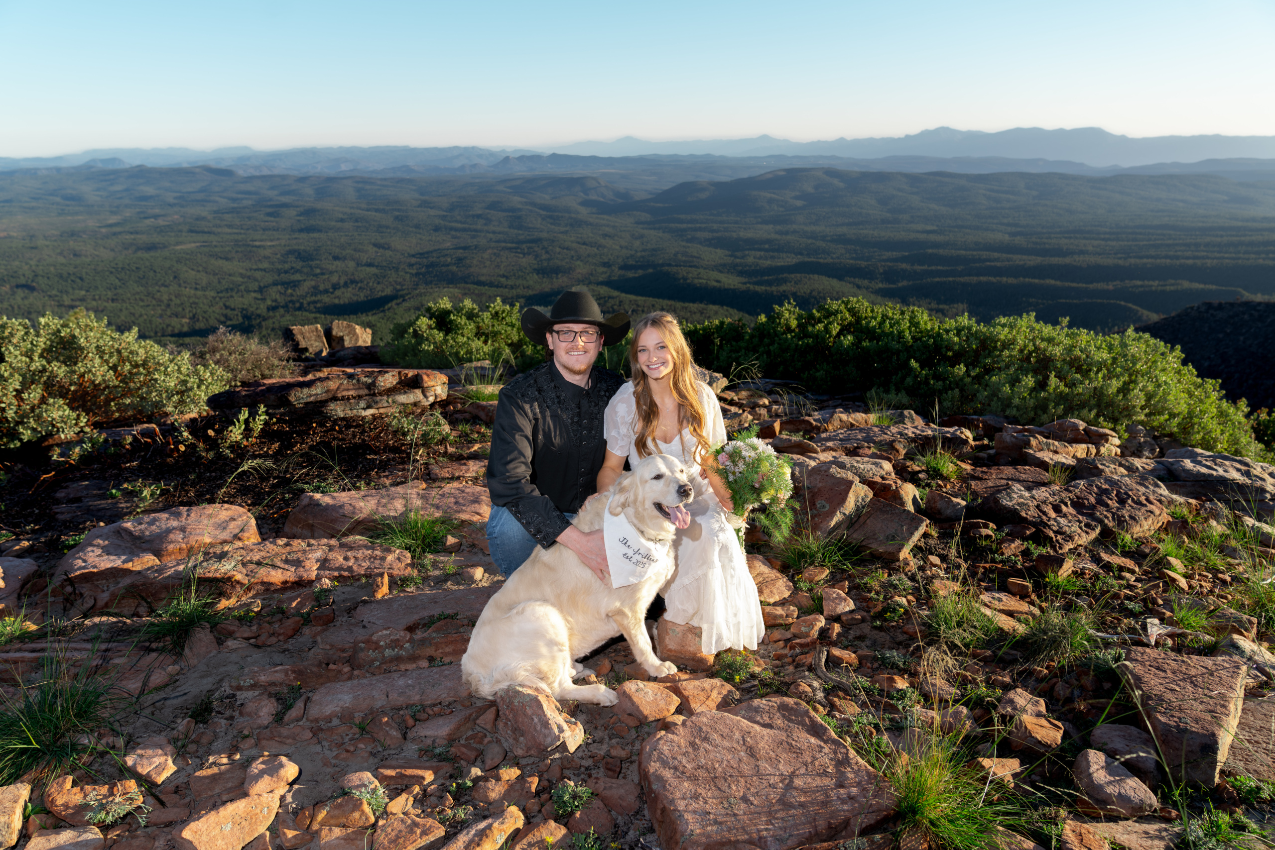 bride and groom at mogollon rim with their dog after eloping in arizona