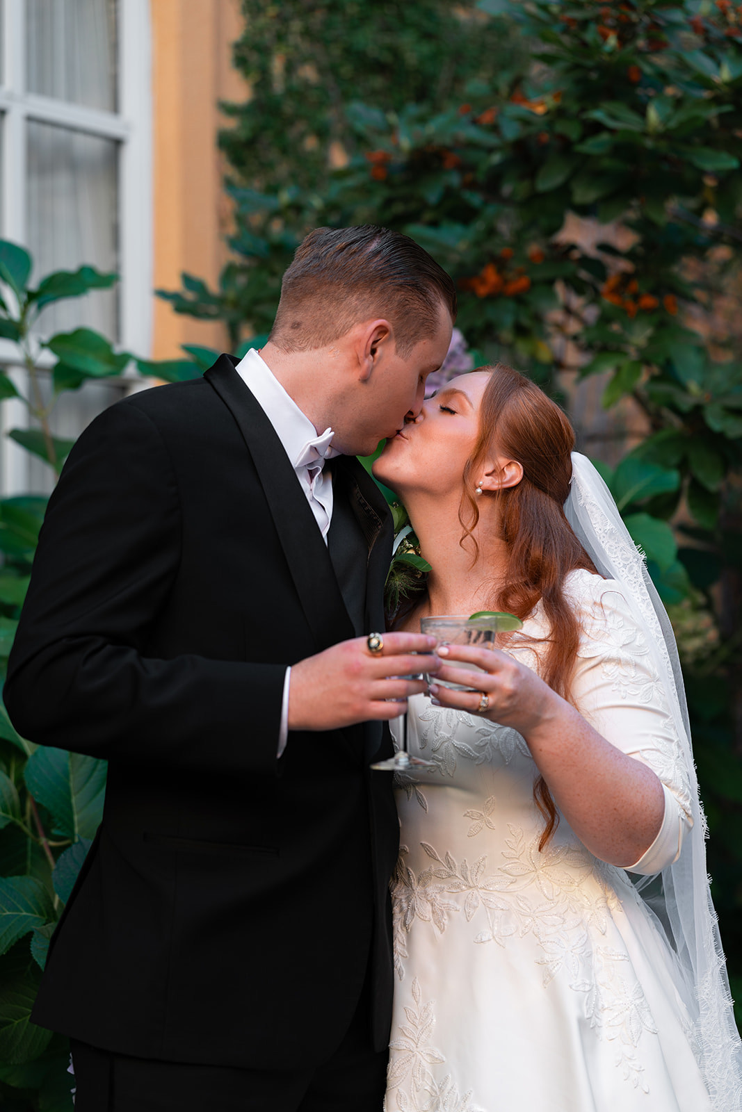 bride and groom kissing in wishing well courtyard at lafayette park hotel