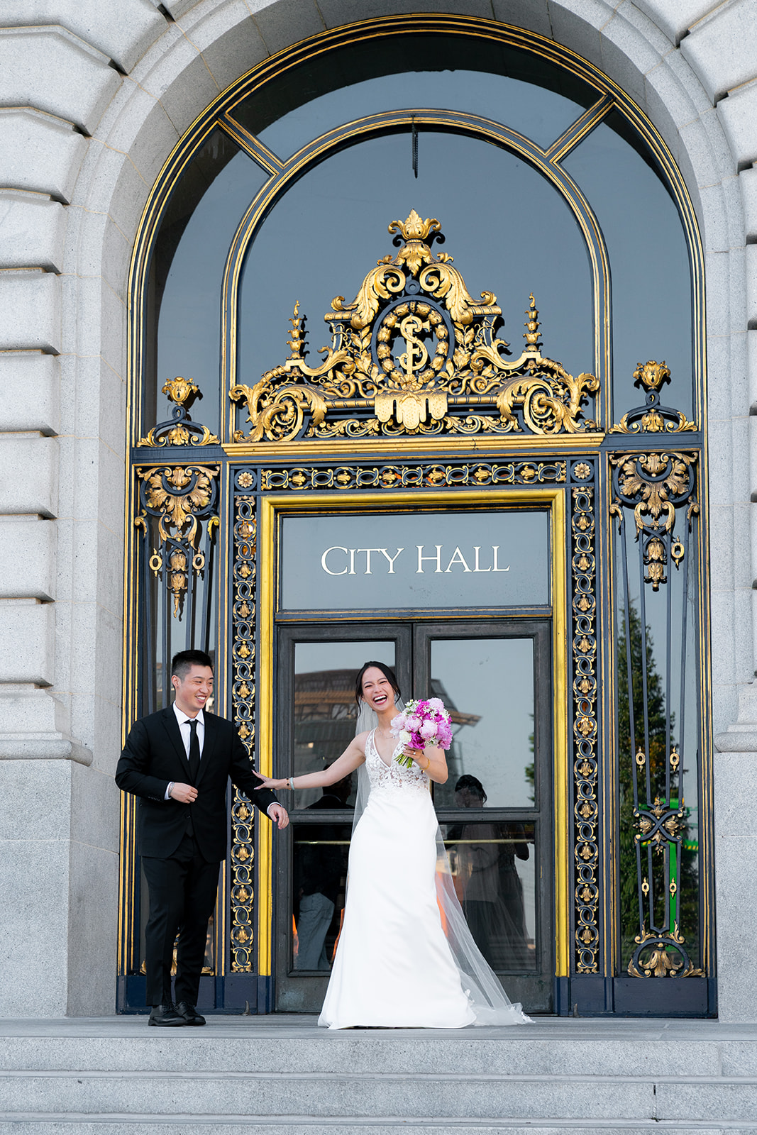 bride and groom leaving san francisco city hall steps