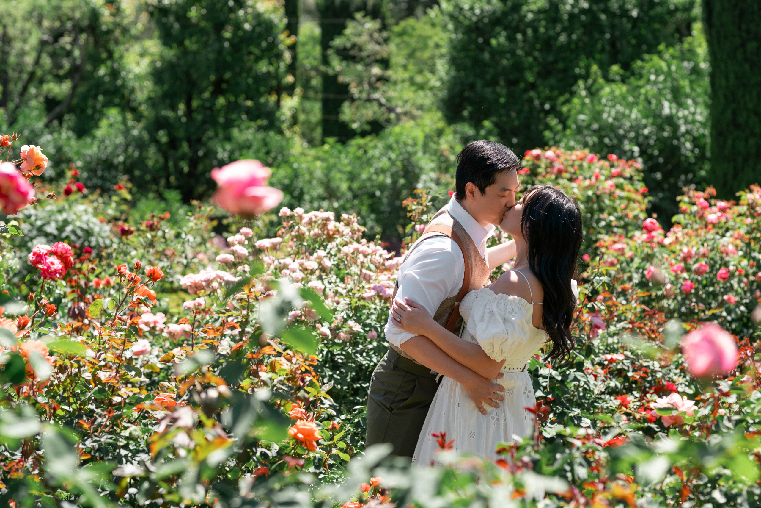 couple kissing in the rose garden at filoli gardens during their engagement photo session