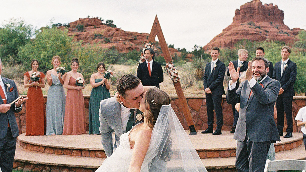 couple kissing at the end of their aisle during sedona wedding ceremony. Photo taken on 35mm film