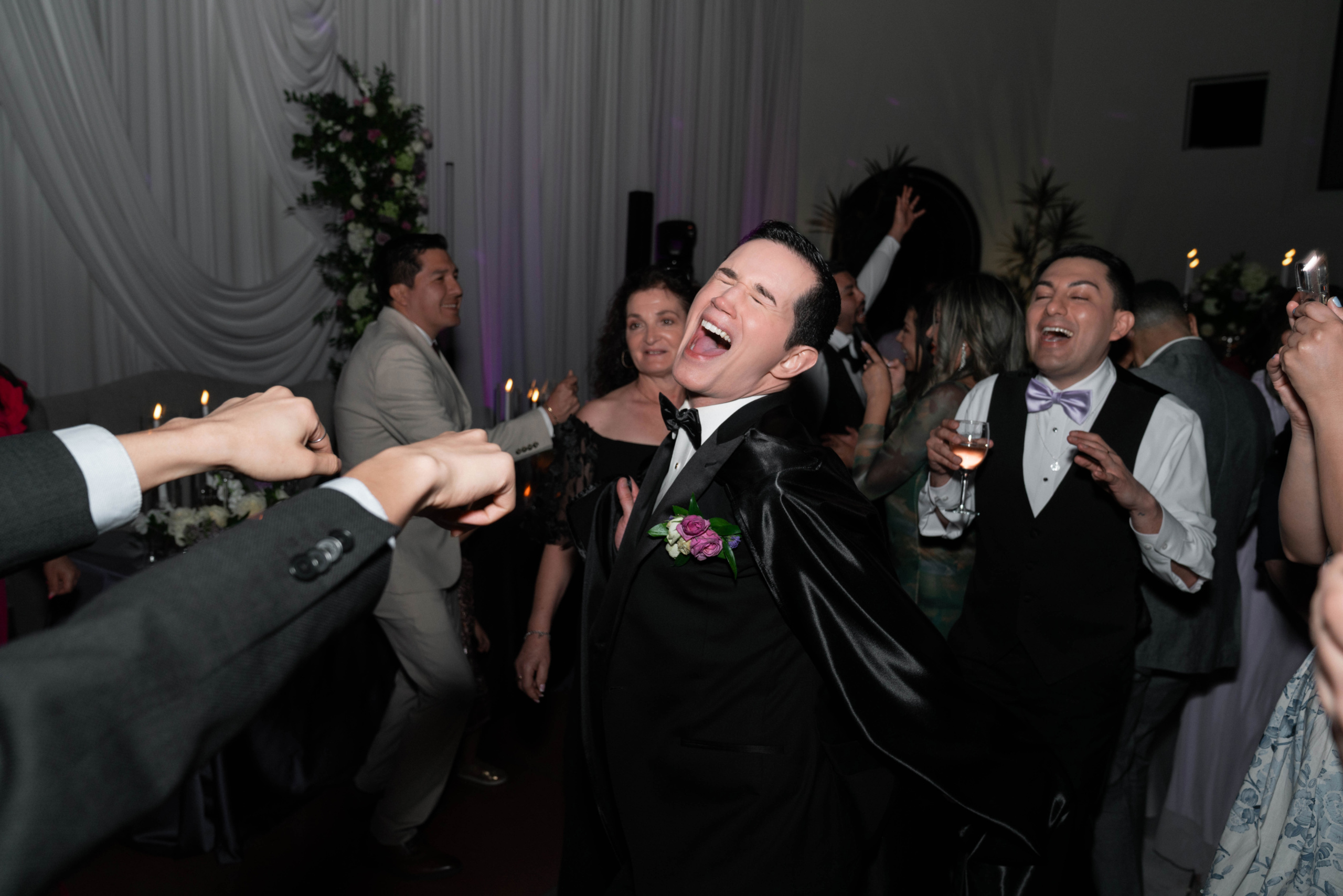 groom screaming into microphone during dancing part of reception at heard museum in phoenix arizona